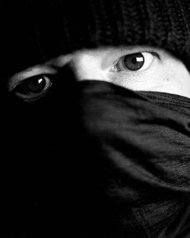 Eyes peering above a scarf, shot on medium format film