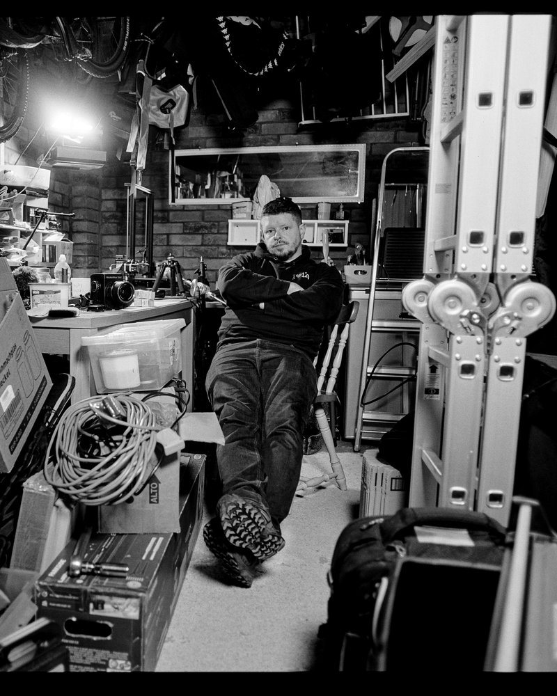 Nick in the garage workshop, surrounded by camera gear